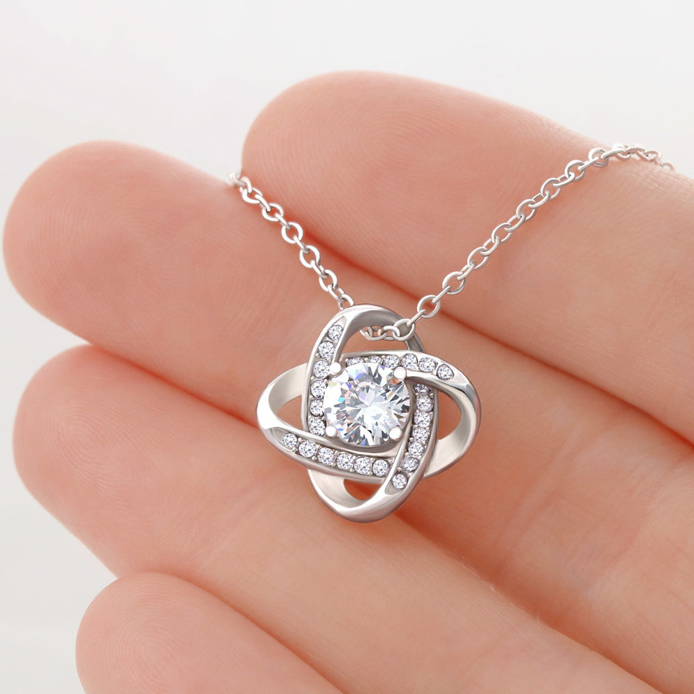 Love Knot Necklace held in hand